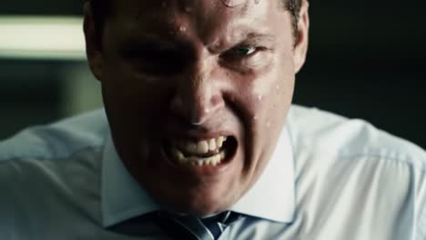 a man in a dress shirt shows intense frustration, pulling at his tie in an office environment. the atmosphere is charged as he expresses strong emotions during a critical situation.