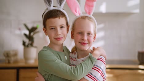 children hugging, wearing easter bunny ears