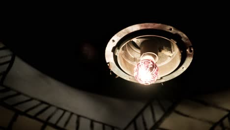 the abstract light turns on in an old shabby light bulb in an abandoned room. darkness