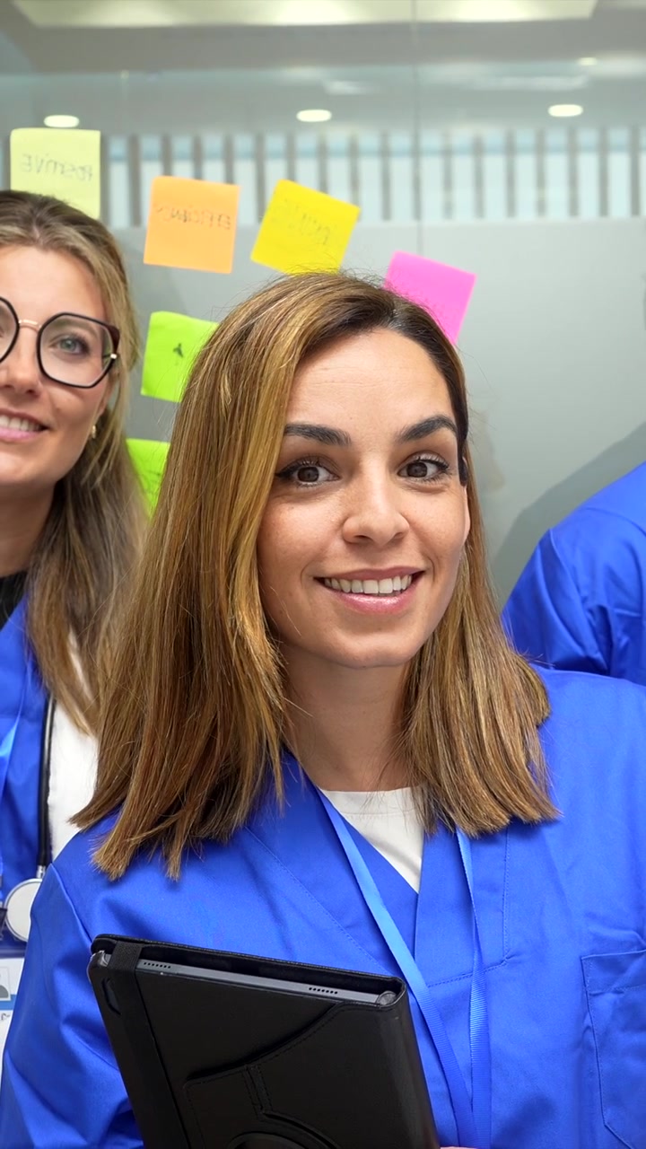 Médica Sorridente Segurando Tablet em Consultório Hospitalar