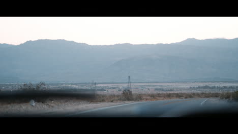 road and horizon seen through moving car windscreen