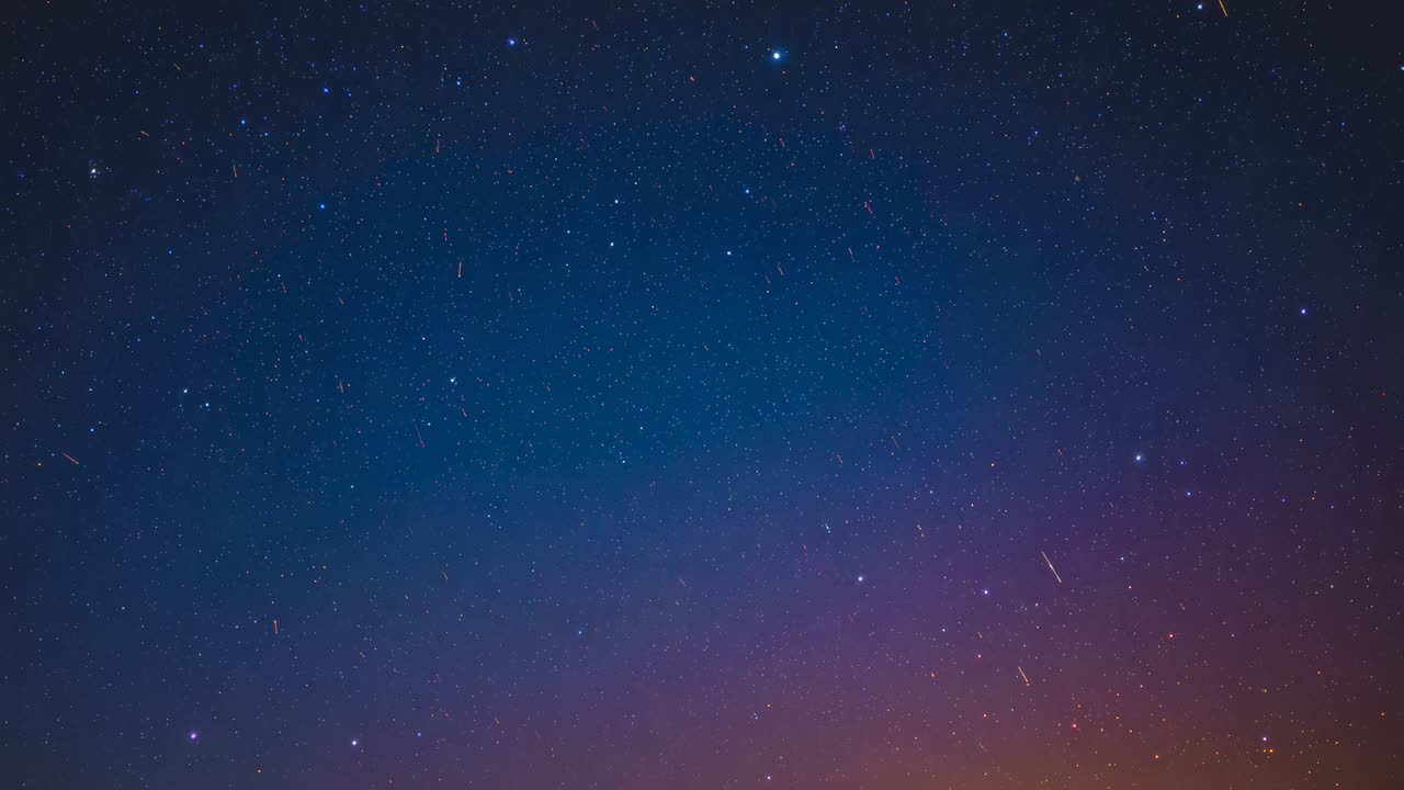 Reaching rural horizon, nightfall leaving orange glow signaling dawn while stars twinkling overhead