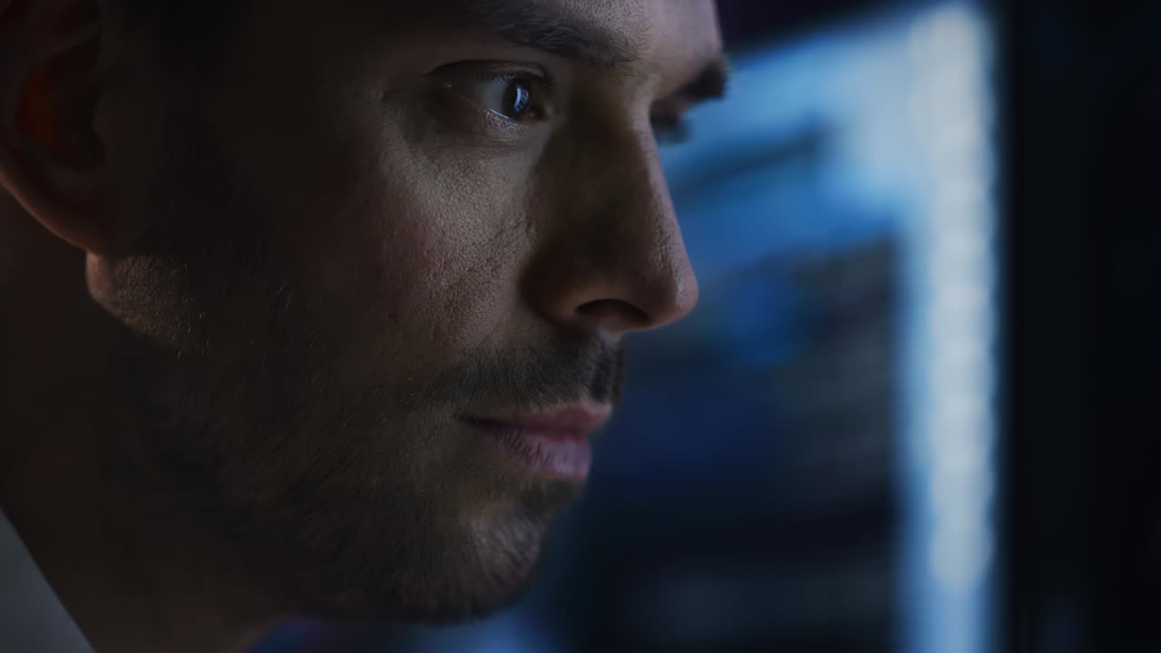 Confident Handsome Man Looks at Monitor Screen with Camera Moving to Computer Screen Showing Data, Infographics, Information, Statistics, Numbers. Businessman Working on Computer in the Office