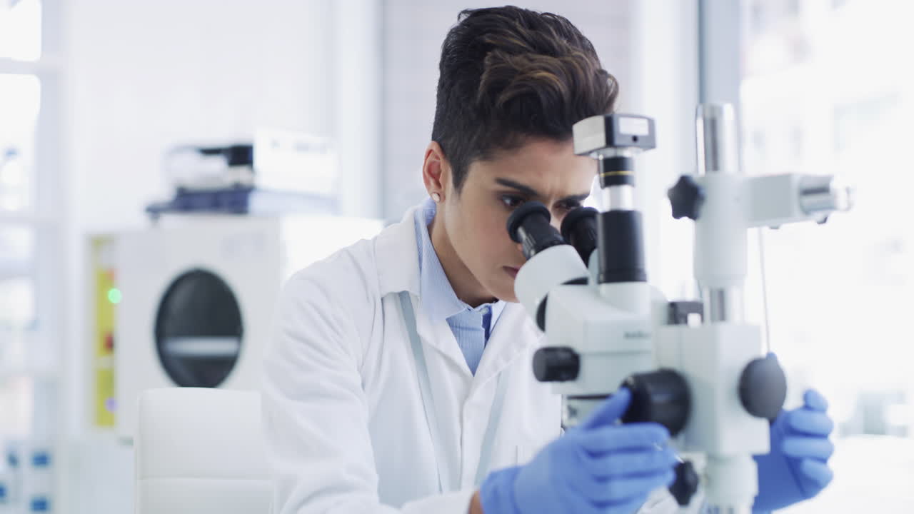 Scientist using microscope in a laboratory