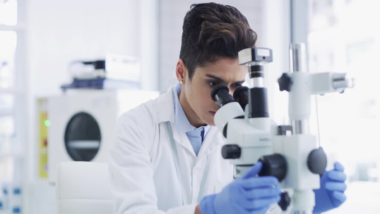Scientist using microscope in a laboratory