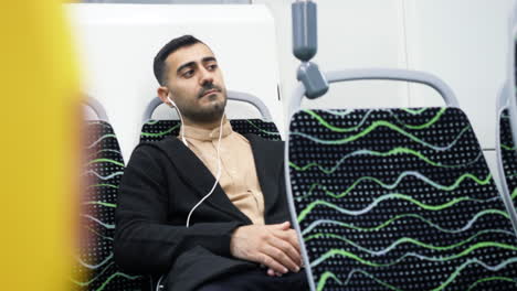 man listening to music on a bus