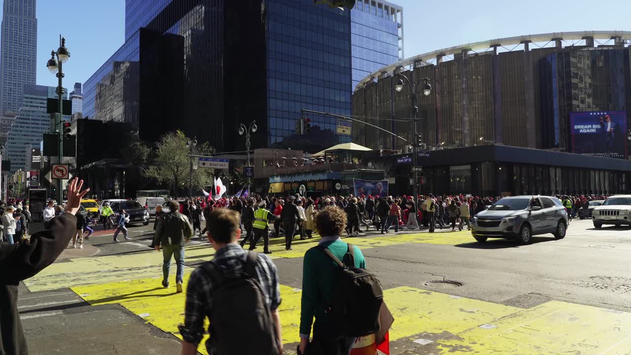 People crowd the streets near Madison Square Garden in New York, their voices rising in support of Trump as the city glows in the afternoon sunlight