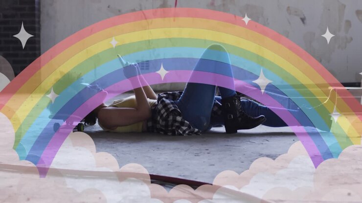 Animation of rainbow and clouds over woman using smartphone