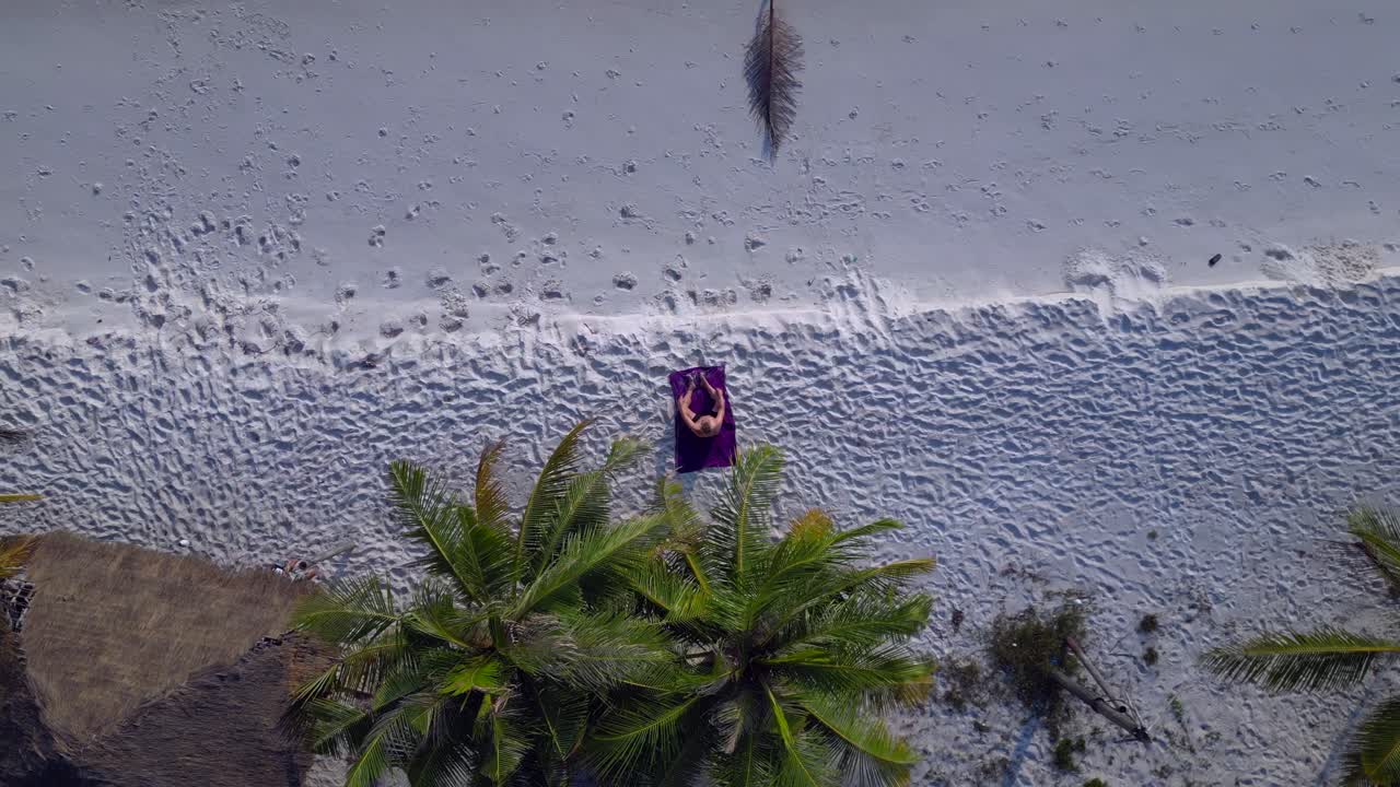 Santa claus is enjoying summer holidays on a beautiful tropical beach. Fabulous aerial view flight drone camera pointing down