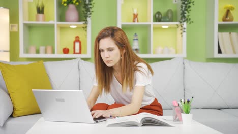 frustrated asian woman working on laptop.