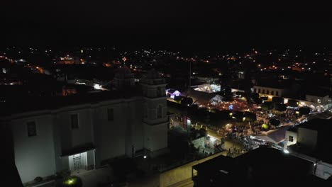 Saint-Mary-of-Guadalupe-temple-in-Tecalitlan,-Jalisco,-night-aerial-orbit