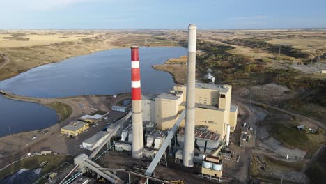 Aerial-4k-footage-of-generating-plant-in-north-american-countryside-during-sunset