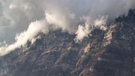 clouds on the churfirsten in the sunshine move quickly along the mountain - walensee schweiz