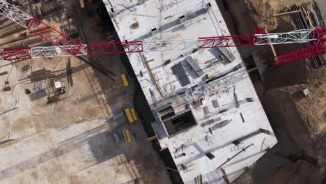 cranes and workers on the construction