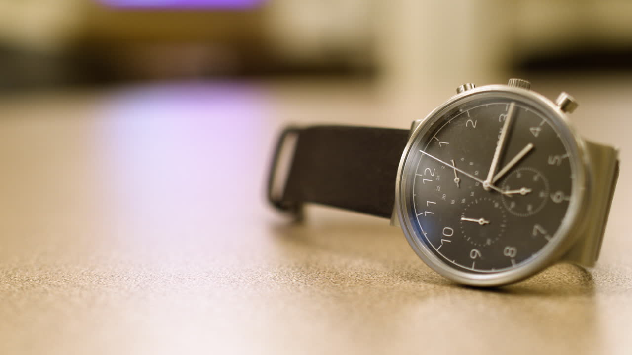 Wrist watch on a table with a blurry background