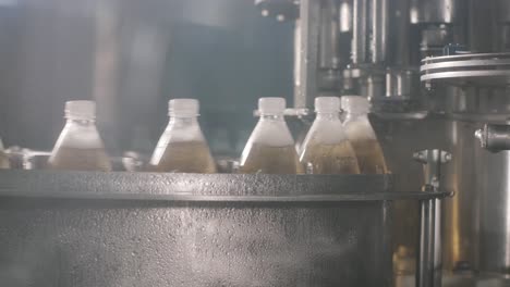 conveyor belt with bottles for juice or water at a modern beverage plant. modern production of sweet soda water