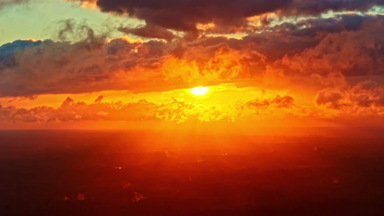 Fiery golden sunset above clouds capturing dramatic colors and stunning natural beauty