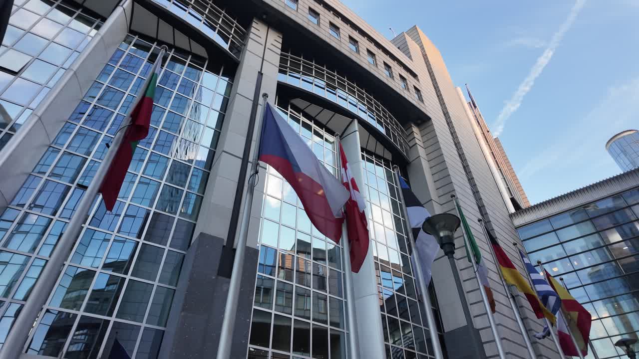 Slow motion pan of national flags at European Parliament Brussels
