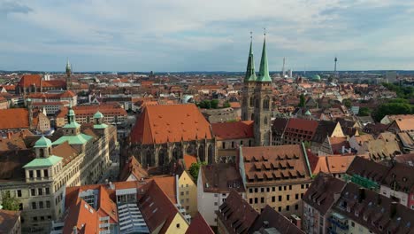 4k aerial drone video of the copper-clad twin spiers on the beautiful st. sebald church in downtown nurnberg, germany