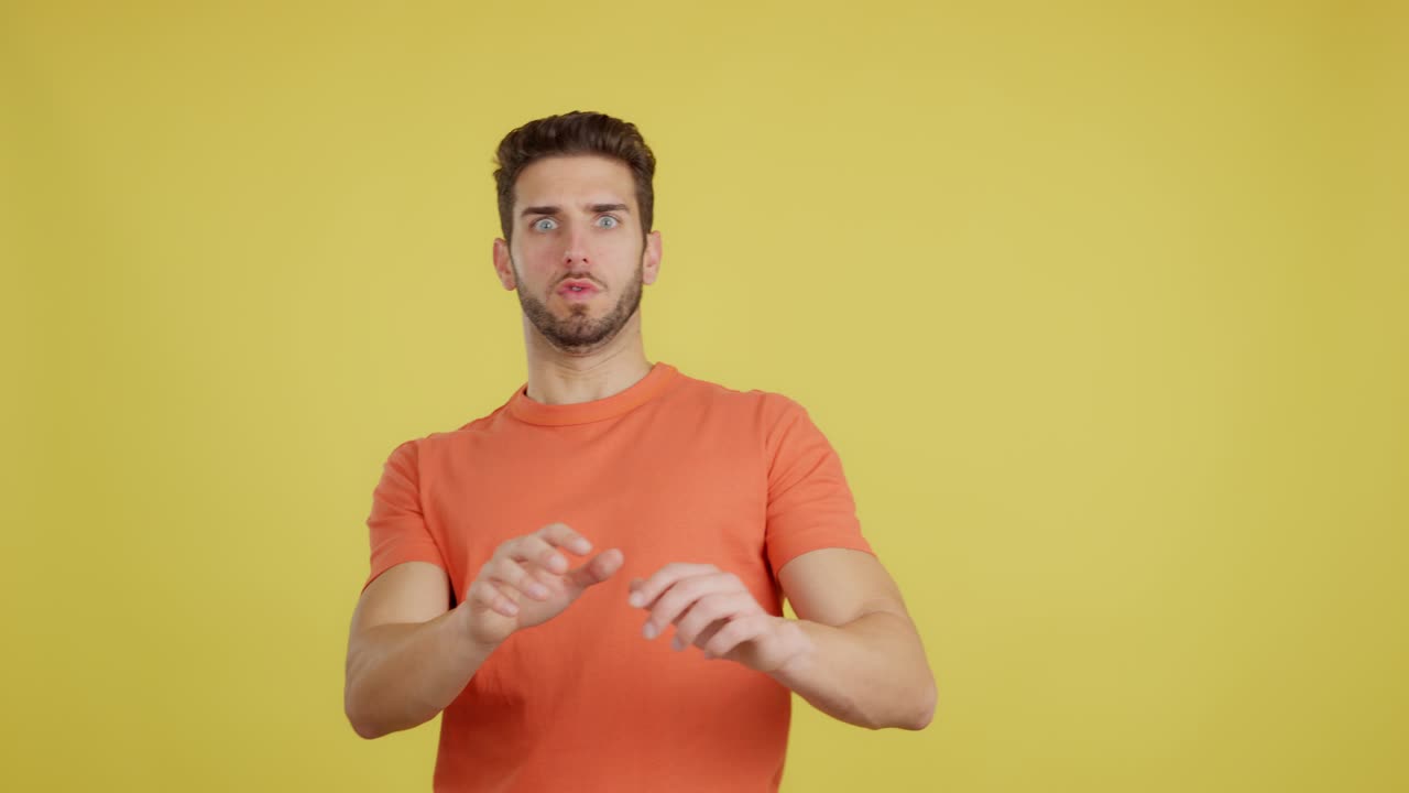 Man with a shocked and surprised expression on a yellow background