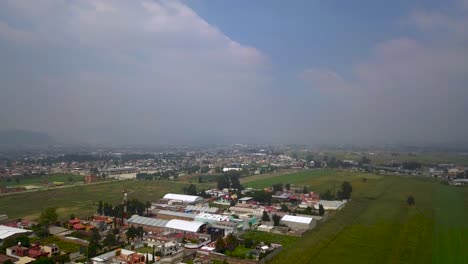 Top-drone-view-of-downtown-the-charming-town-of-chalco-Mexico,-and-view-of-the-downtown-and-roads-towards-Mexico-City