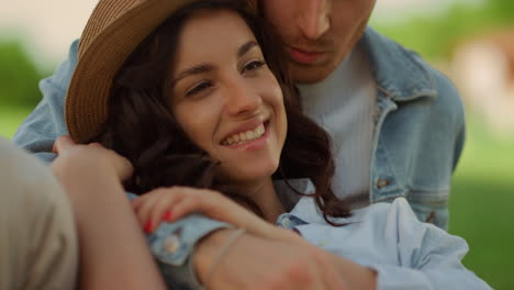 affectionate couple spending time on picnic. girl and guy lying on grass