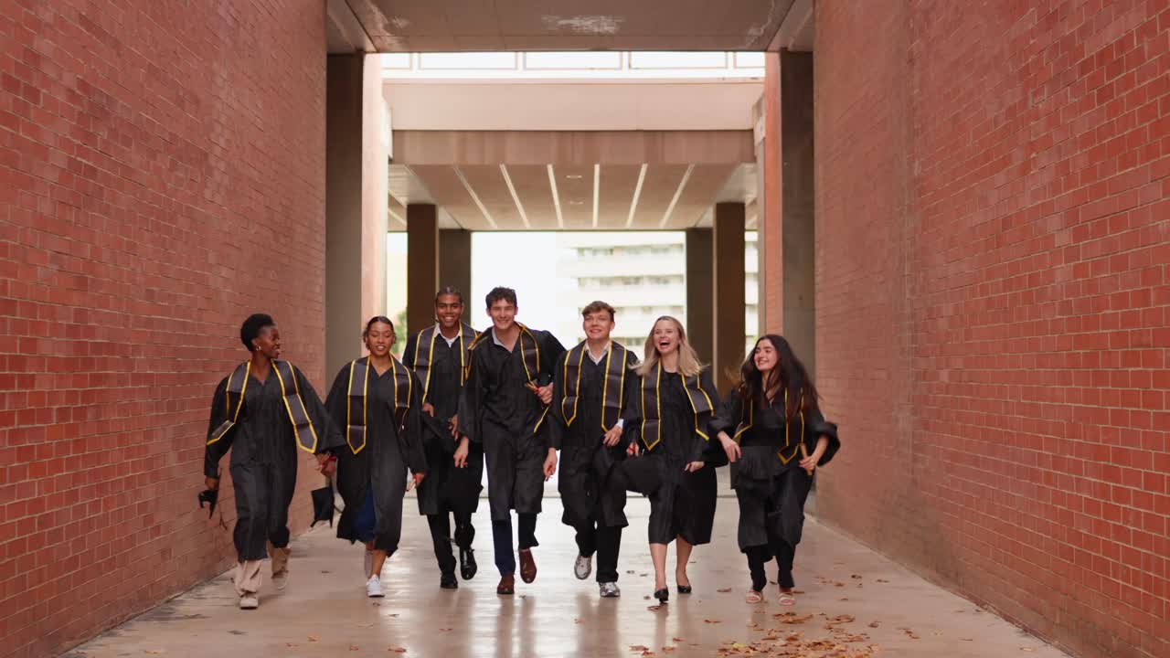 Graduates celebrate throwing their caps in the air