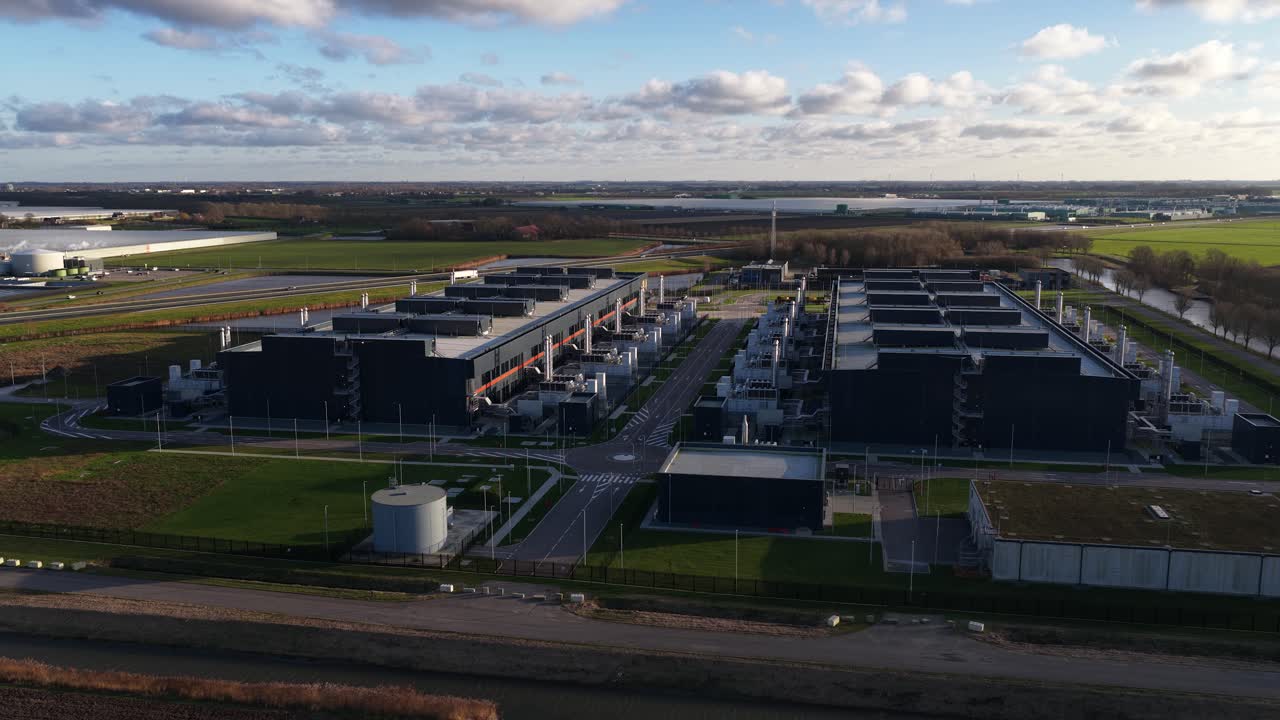 Aerial video of a large scale data center in The Netherlands, redundant computing infrastructure, emergency backup power generators, AI technology supporting big data processing and cloud services