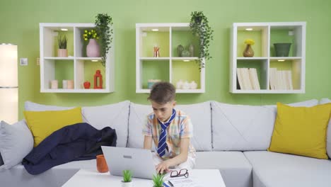 boy pretending to be a businessman throws his jacket on the sofa. funny boy.