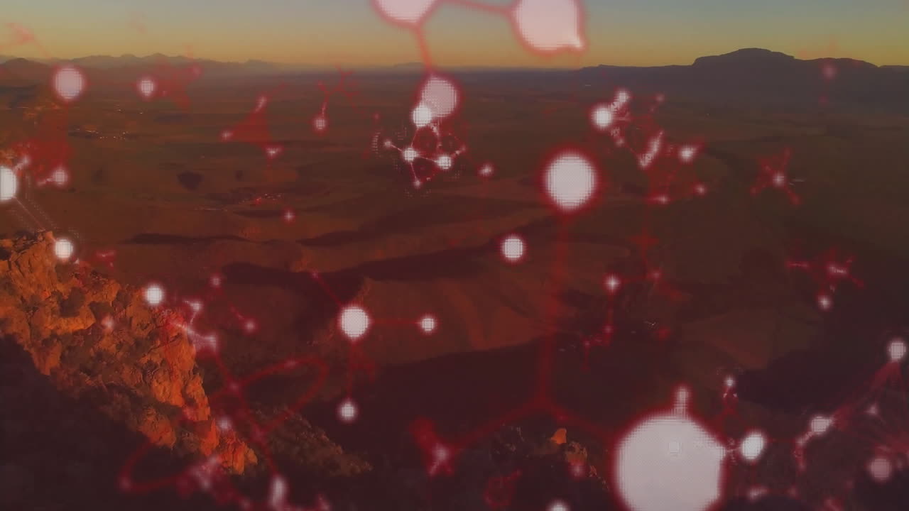 Red molecular structure animation over scenic mountain landscape at sunset