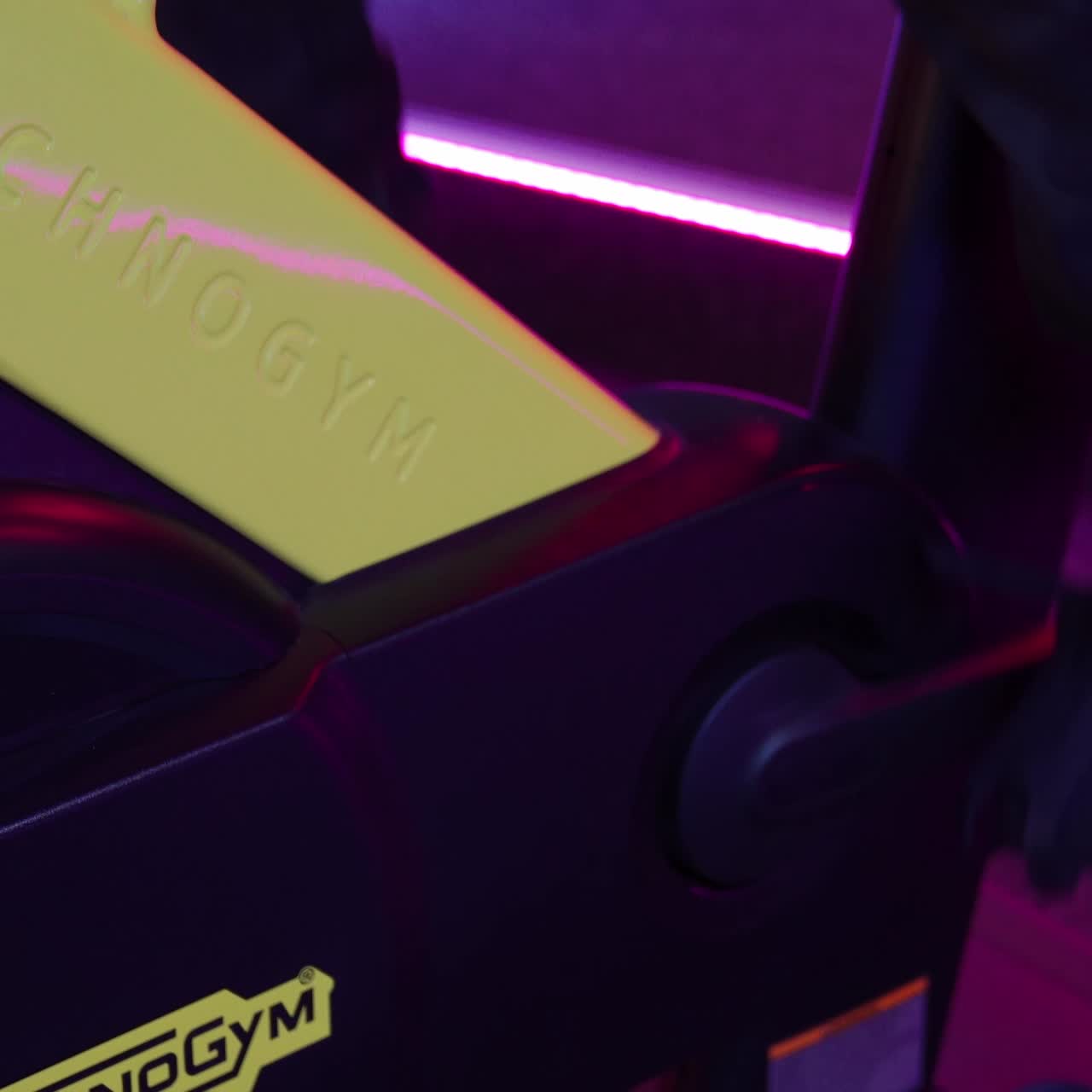 Speedy bicycle ride in fitness centre. Stationary bike cardio workout in sport gym