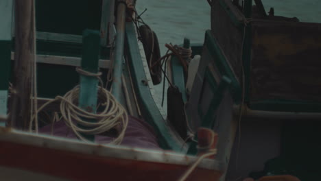 wooden fisherman boat moored at bay during a day of storm on the sea ocean