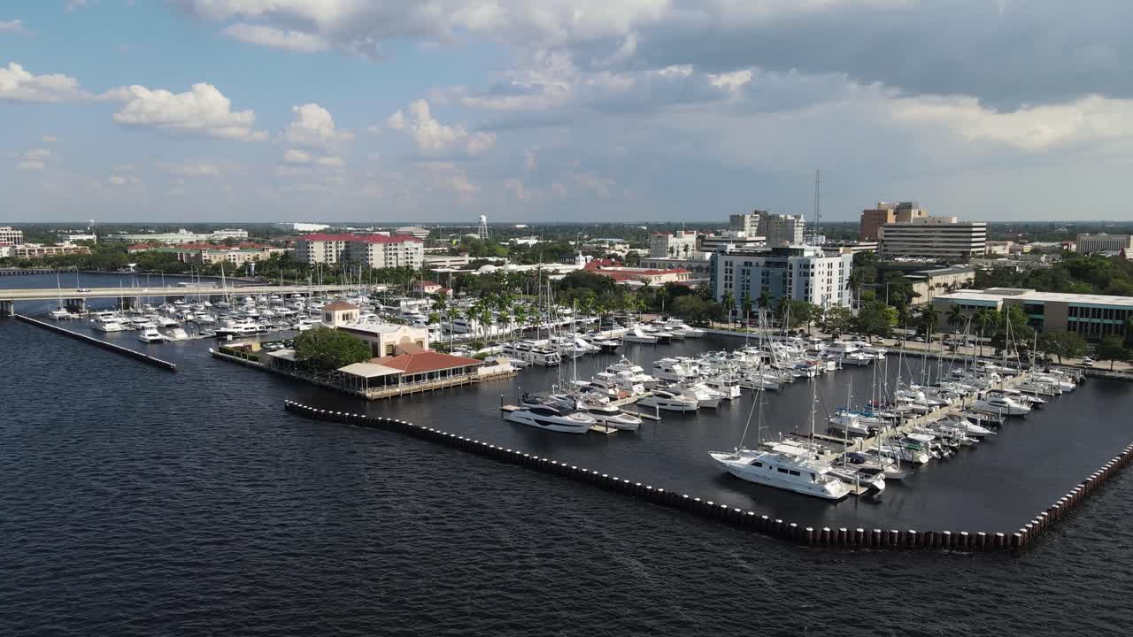 Aerial view of Bradenton marina with boats docked and the city skyline over the Manatee River. Dolly Forward Day
