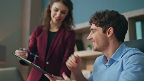 girl assistant bringing coffee to working businessman in office close up.