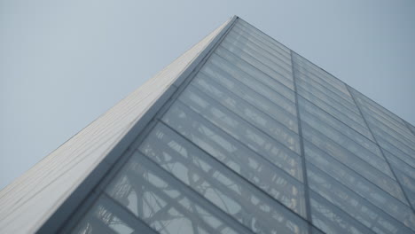 popular louvre glass pyramid museum, low angle, close up, rack focus