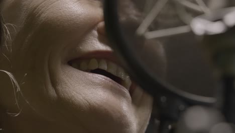 Woman-singing-into-professional-microphone-in-studio,-close-up-view