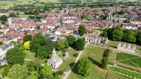 panning drone aerial glastonbury abbey ruins somerset town in background