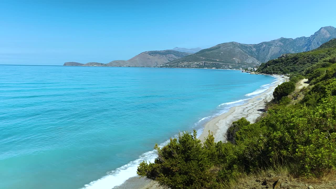 Green and blue panorama of beautiful coastline in Albania, Olive trees, hills and mountains on amazing bay with white beaches and turquoise sea water