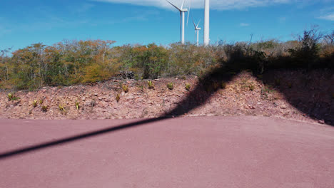 aerial truck shot of wind turbine shadows on desert ground