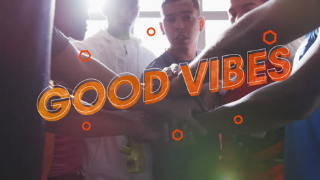good vibes text against male coach and team of male soccer players making a hand stack