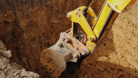 Excavator-Bucket-Digs-A-Hole-For-Communications