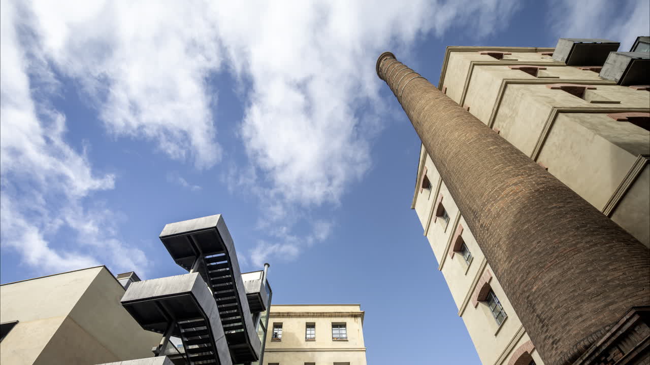 Old factory chimney and apartment buildings in barcelona