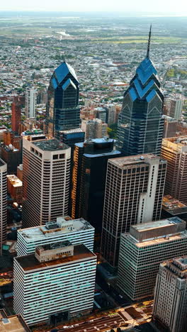 group of skyscrapers standing out in the plain architecture of the city. beautiful view of philadelphia on sunny day. vertical video