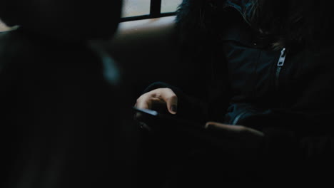 woman-hands-using-digital-tablet-computer-driving-in-car-browsing-online-messages-reading-social-media-enjoying-mobile-internet-connection-traveling-in-city-on-cold-rainy-day