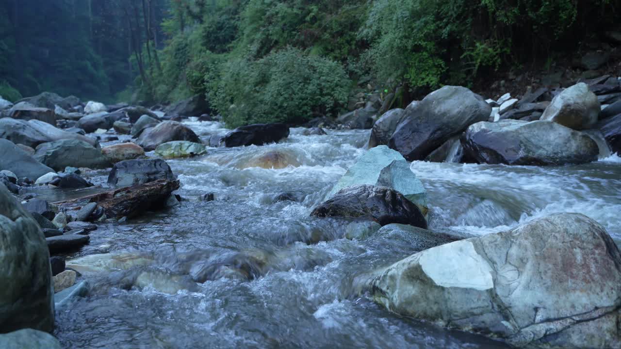 Water is flowing through a mountain torrential river.