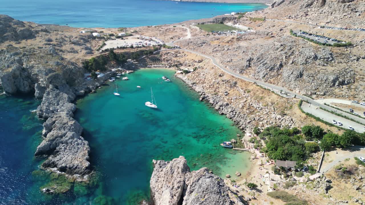 Famous St ’s Bay, Lindos aerial drone approach on a sunny morning, Rhodes, Greece