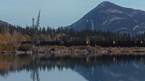 factory tower and train in the mountains by the lake