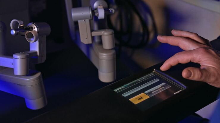 Male hands set parameters on the sensor panel of Da Vinci robot. Close up. Managing advanced technological equipment.