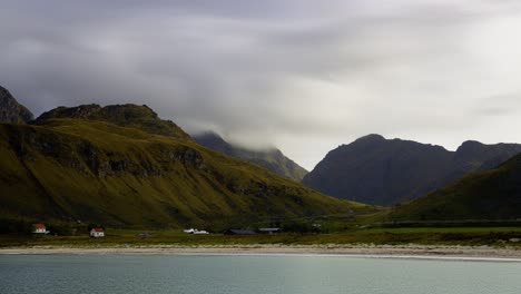 View-of-a-small-village-in-a-valley-by-the-open-sea,-Lofoten-islands,-North-Norway