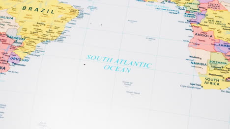 close-up of the word south atlantic ocean on a world map with the detailed name of the capital city